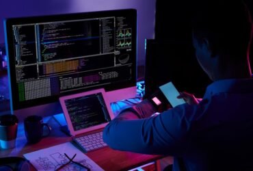 programmer-scanning-screen-his-smartwatch-with-smartphone-camera_1098-18710